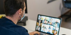 man in blue long sleeve shirt using black laptop computer